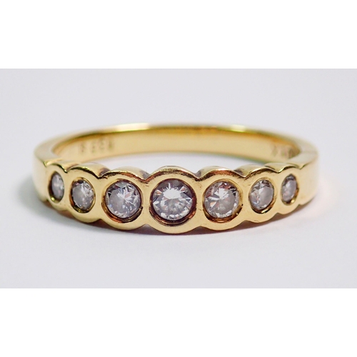 370 - An 18 carat gold ring inclusion set seven graduated diamonds, size O, 3.7g