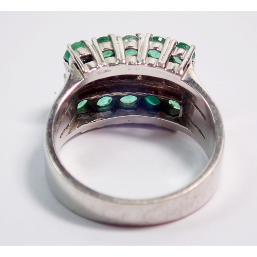 374 - A 14k white gold ring set five diamonds flanked by ten emeralds, size N, 6.8g