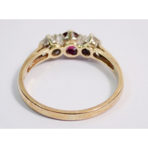 382 - A 9 carat gold ring set ruby flanked by two diamonds, size Q to R, 2.3g