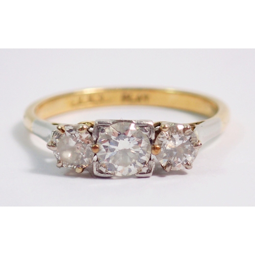 386 - An 18 carat gold and platinum set three stone diamond ring, size K, 2.4g