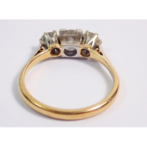 386 - An 18 carat gold and platinum set three stone diamond ring, size K, 2.4g