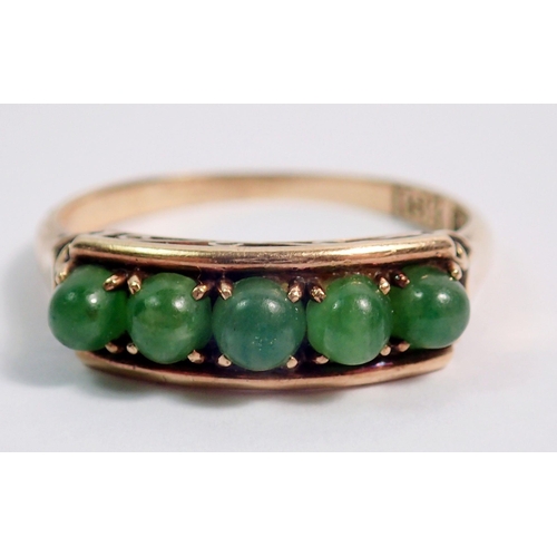 389 - An 18 carat gold ring set five cabochon cut green stones, size L to M, 2.2g