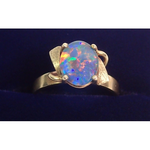 390 - A 9 carat gold ring set opal doublet in scroll mount, size N, 3g