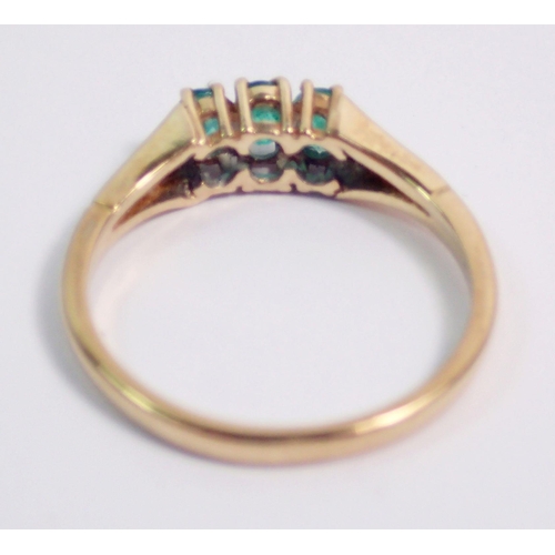 394 - A 9 carat gold ring set green stones, size N/O, 2g