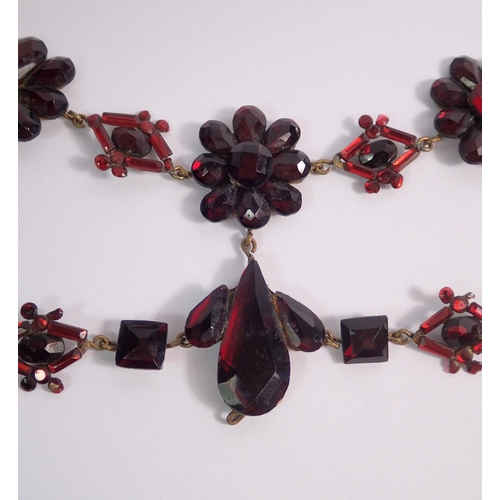 410 - A Victorian Vauxhall glass necklace with floral cluster and geometrical links, in need of repair