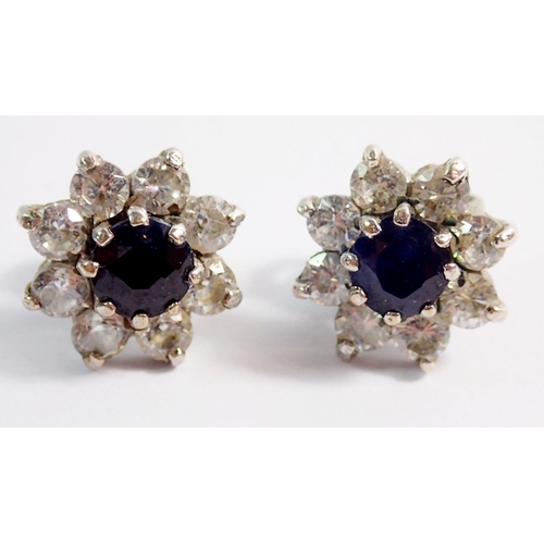 470 - A pair of white metal sapphire and white stone cluster earrings, unmarked