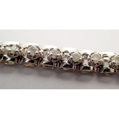 473 - A 9 carat white gold diamond tennis bracelet, 18.5cm long, 10.9g