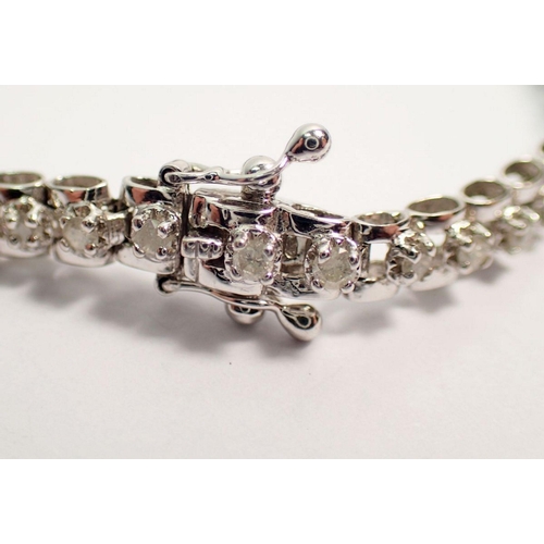 473 - A 9 carat white gold diamond tennis bracelet, 18.5cm long, 10.9g