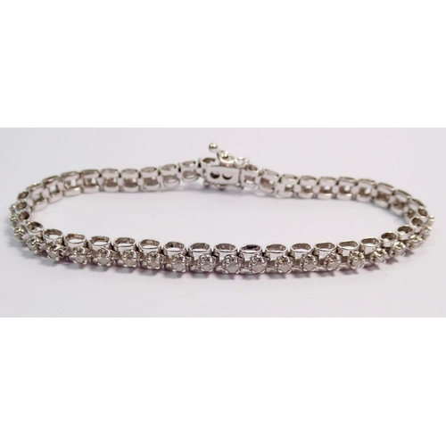 473 - A 9 carat white gold diamond tennis bracelet, 18.5cm long, 10.9g