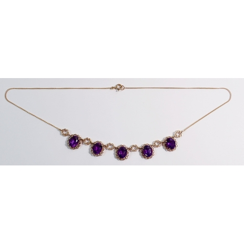 478 - A 9 carat gold necklace suspended five oval cut amethysts within scrollwork surrounds, 44cm, 9g