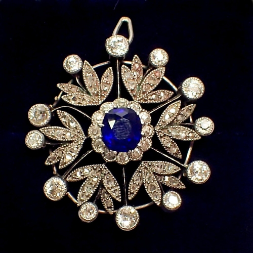 483 - An early 20th century circular pendant set central sapphire within diamond set surround, 2.5cm diame... 