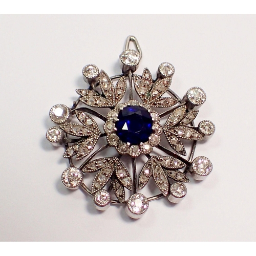 483 - An early 20th century circular pendant set central sapphire within diamond set surround, 2.5cm diame... 