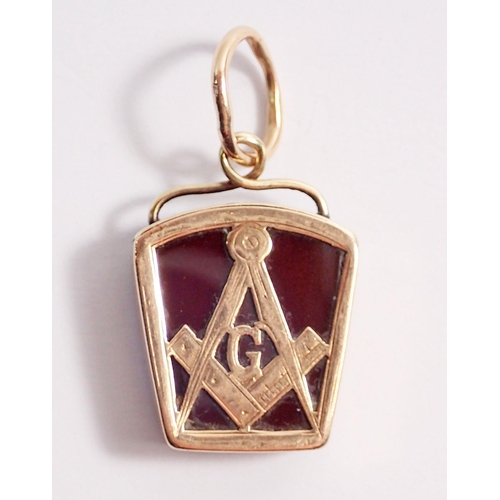 484 - A Masonic 9 carat gold pendant with compass motif mounted on orange stone and bloodstone to reverse,... 