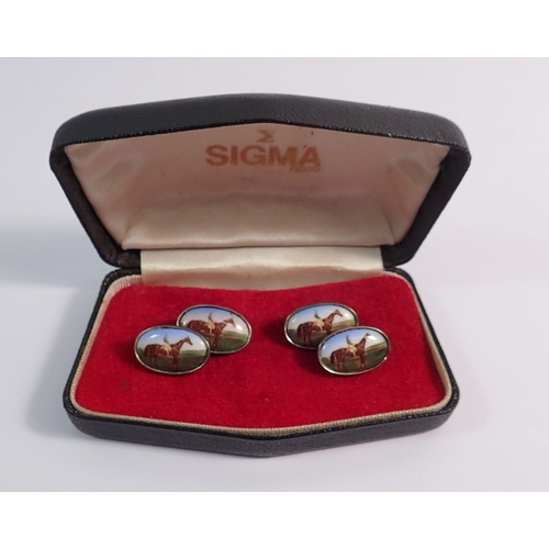 557 - A pair of silver cufflinks decorated racehorses - boxed