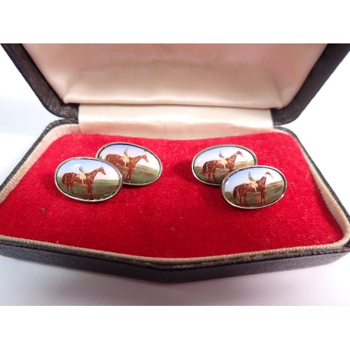 557 - A pair of silver cufflinks decorated racehorses - boxed