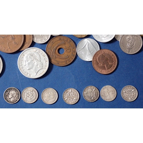 692 - A group of 20th century British and world coins including seven pre 1947 silver content threepence c... 