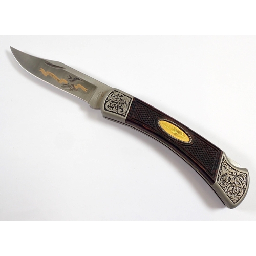 909 - A John Wayne Buck model 110 folding knife, The Duke - boxed