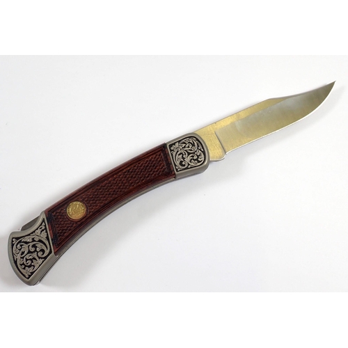 909 - A John Wayne Buck model 110 folding knife, The Duke - boxed