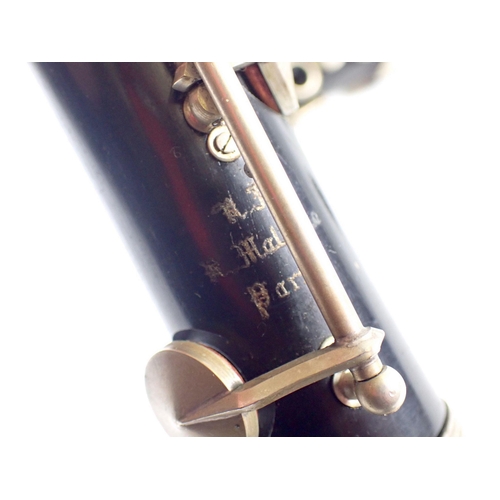 913 - An old brass trumpet and a Malerne of Paris clarinet, both cased