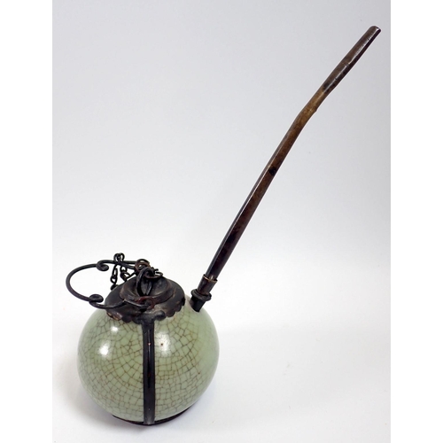 935 - An antique Louse green porcelain and metal opium pipe from Northern Laos, 15cm tall to top of pipe