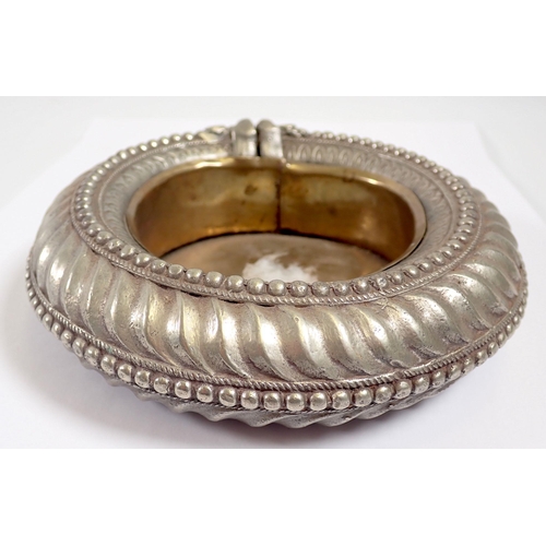 943 - A white metal slave bangle converted to an ashtray, 15cm diameter