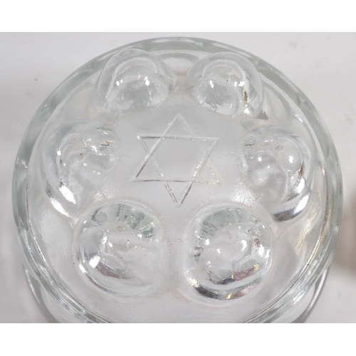 984 - A Jewish brass novelty oil lamp ashtray and a Star of David glass jelly mould