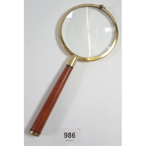 986 - A vintage English made magnifying glass with leather handle by P H Vogel & Co, 21cm long