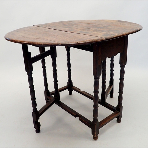 1137 - An 18th century oak oval dropleaf supper table on turned supports, 74 x 102cm