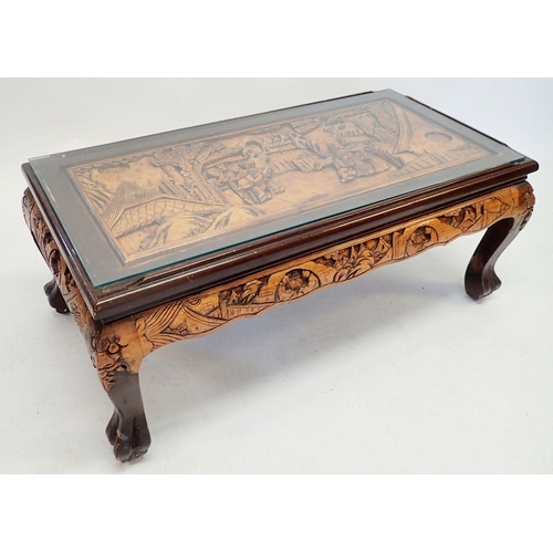 1148 - A Chinese carved coffee table with glass top and claw feet, 102 x 51cm