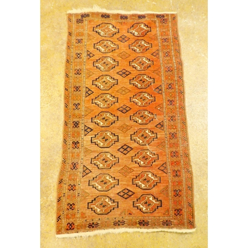 1149 - An antique Turkoman rug with two rows of guls on a madder ground, 152 x 84cm