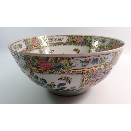 128 - A large modern Chinese Canton style bowl decorated interior scenes and panels of flowers, 35cm diame... 