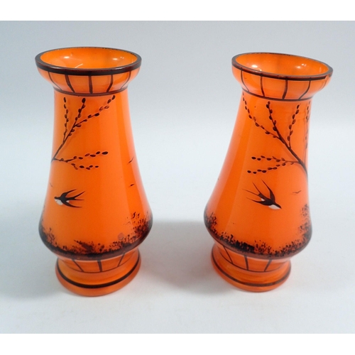 174 - A pair of Loetz style orange 1930's vases painted swallows and trees, 13cm tall