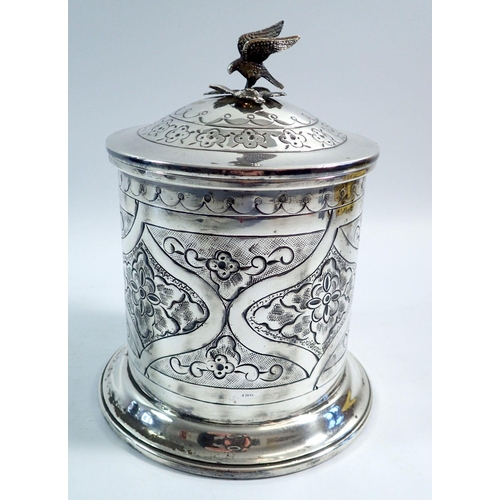 190 - A silver plated biscuit barrel with embossed decoration and bird finial 19cm tall