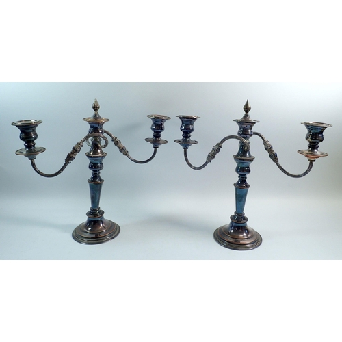 191 - A pair of silver plate on copper three branch candelabra with removable central finials, 33cm tall