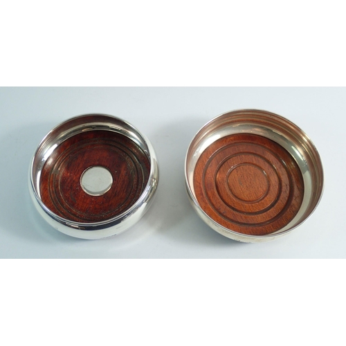 223 - Two silver mounted wooden bottle coasters, Sheffield 1973 and Birmingham 2004, largest 10.2cm diamet... 