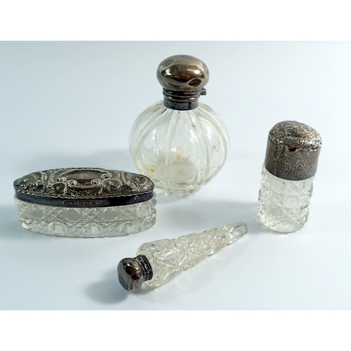 238 - A silver topped ribbed glass scent bottle, Birmingham 1916, 8cm tall, another scent bottle, a simila... 