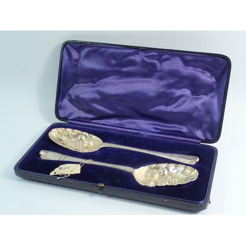 244 - A pair of Queen Anne Britannia silver tablespoons later embossed fruit as berry spoons, cased, 117g