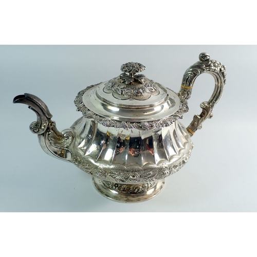 276 - A Georgian silver four piece tea service with rose finials and fluted body, with further floral band... 