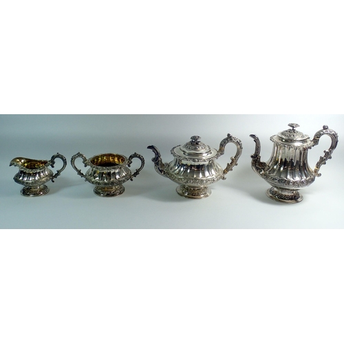 276 - A Georgian silver four piece tea service with rose finials and fluted body, with further floral band... 