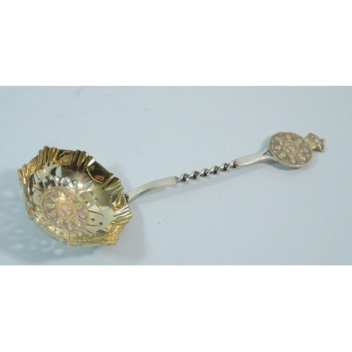 296 - A Queen Victoria silver gilt commemorative sugar sifter spoon decorated heads of Victoria and her ch... 