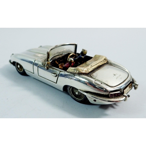 297 - A silver model E Type Jaguar convertible by Gordon Yates with two enamel figures, set ruby rear ligh... 