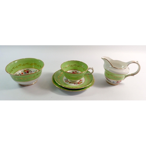 30 - A Worcester style apple green and floral painted tea service comprising twelve cups and saucers, twe... 