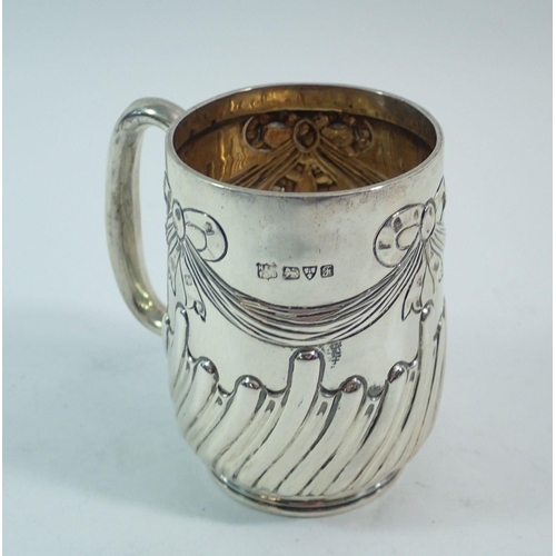 304 - A silver christening mug with ribbon and swag decoration, 8cm tall, Chester 1906, Barker Brothers, 1... 