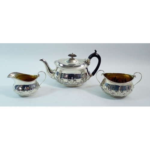 306 - A silver three piece bachelors tea set with embossed decoration, London 1903 by William Hutton & Son... 