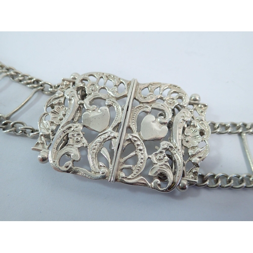 323 - An Edwardian Art Nouveau silver belt with scrollwork and heart motifs, 76cm long, E S Barnsley & Co.... 