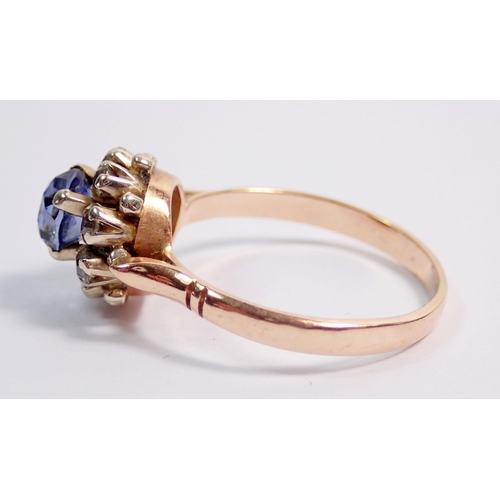 338 - A 14 carat gold ring set pale blue sapphire within white stone surround, size O to P