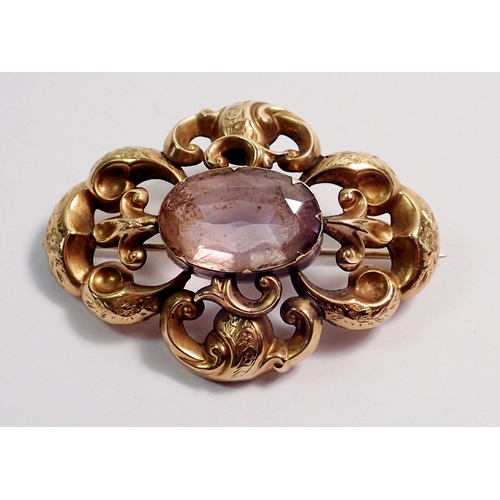 379 - A Victorian gold scrollwork brooch set amethyst, unmarked but tested as 18 carat gold, 5cm wide, 8.1... 