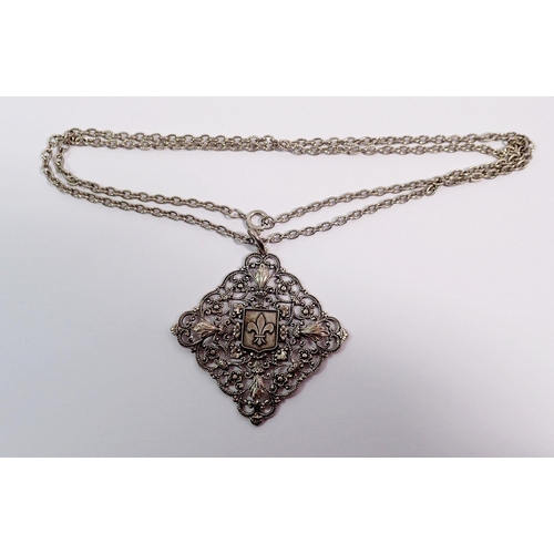 395 - A French white metal pendant decorated fleur de lys