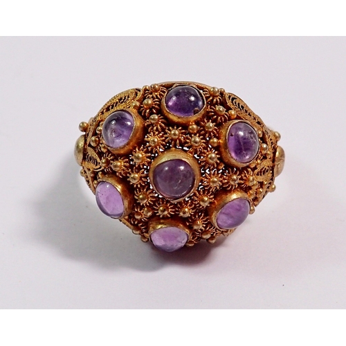 405 - A silver gilt vintage Eastern domed ring set seven cabochon cut amethysts, adjustable size