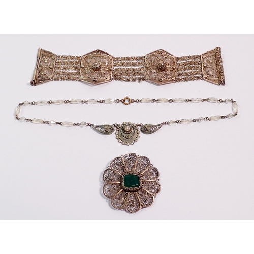 413 - A group of white metal filigree jewellery comprising brooch set green stone, paste pendant and brace... 